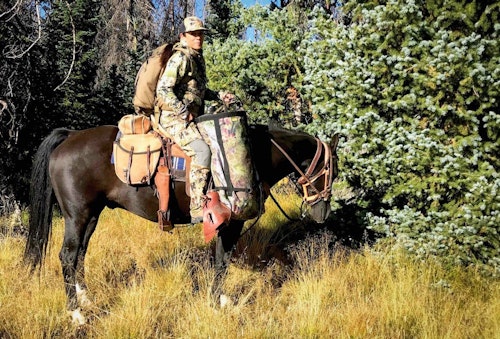 The author with her bow in the saddle scabbard, pursuing Colorado bulls.