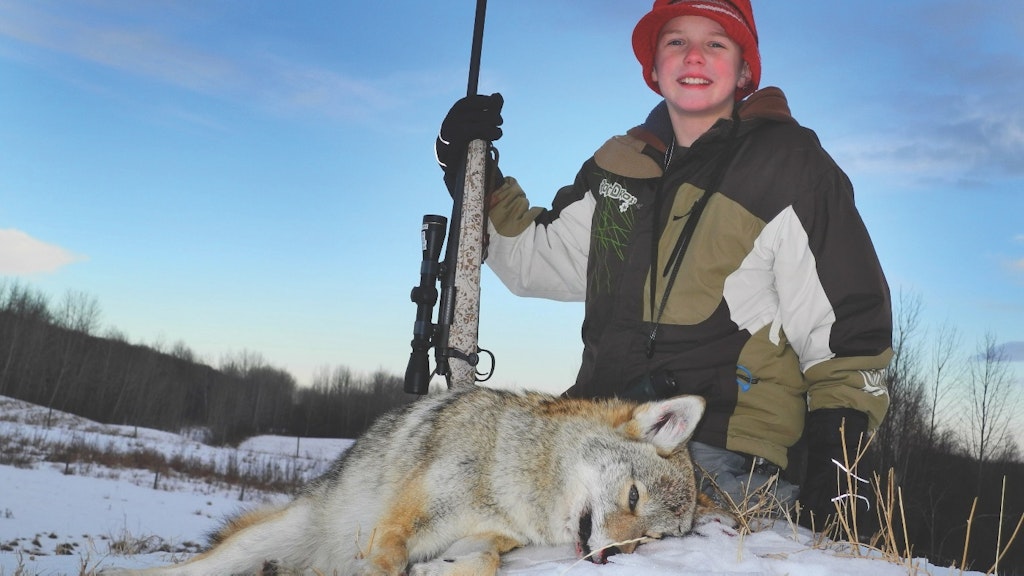 This young hunter bagged his first coyote with a 166-yard shot. 