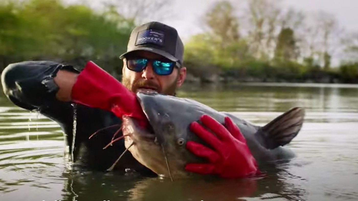 Man Puts His Hand Under a Log and Pulls Out Giant Fish https://cole-grandviewoutdoors.imgix.net/https%3A%2F%2Fwww.grandviewoutdoors.com%2Fuploads%2Fimages%2FBerkley-noodling-glove-pic.jpg?fit=clip&ixlib=php-1.1.0&q=85&s=0d1600e5b0bf5811201e3544f79f1939&w=1400