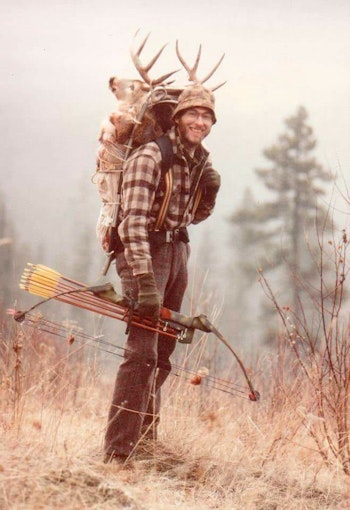 Dwight Schuh carrying one of the first compound bows on a successful deer hunt.