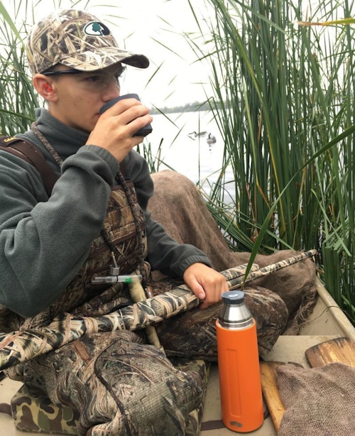 When the shooting slowed, the author’s son treated himself to hot chocolate in the duck blind.