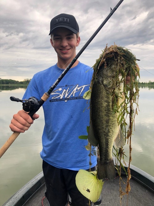 The author’s oldest son Elliott with a 4-pound Minnesota largemouth and a bouquet of frog fishing habitat, too.