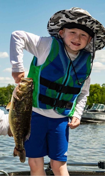 Anglers of all ages come out to support Teen Challenge and catch fish in the event. Theo Harper is excited to bring his bass to the weigh-in.