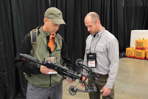 The author (left) checking out and shooting the new Barnett Hyper Raptor during the 2023 ATA Trade Show.