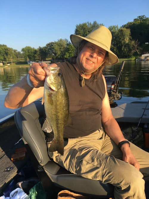 The author's fishing partner, above, really wanted fresh fish for a meal, and because they didn't catch any small northern pike for the table, they kept a single bass that measured 15 inches.