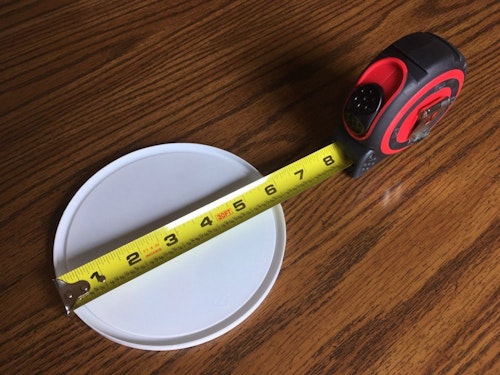 FYI: The cover of a whipped topping tub (above) measures almost exactly 6 inches in diameter. It works well as a 30-yard bull’s-eye, or you can trace it to cut more bull’s-eyes. The cover of a 1-gallon ice cream container (below) typically measures 8 inches and is great for practicing at 40 yards.
