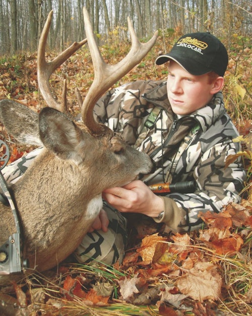 A teenager, the author admires his first buck from more than 15 years ago. He coaxed the buck within bow range via grunting, snort wheezing and rattling.