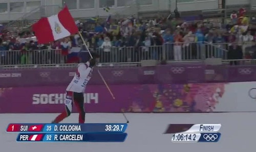 Cross-country skier Roberto Carcelen holds the Peruvian flag as he nears the finish line during the 2014 Winter Olympics. (Photo from Roberto Carcelen Facebook)