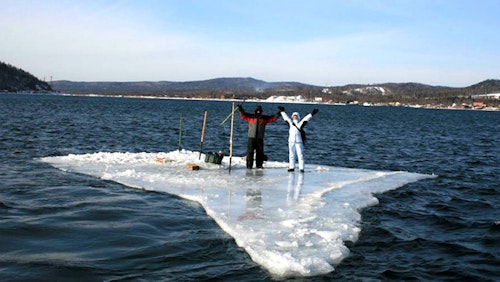 Two Russian anglers who were previously stranded on a large sheet of ice chose to paddle a smaller sheet of ice to safety. Photo courtesy of Russian Emergency Situations Ministry press service via AP.
