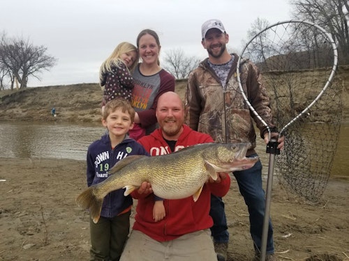 Volk’s family was playing in a nearby park when he landed his 16-pound 9-ounce walleye with help of his friend/net-man Joe Gibbs.