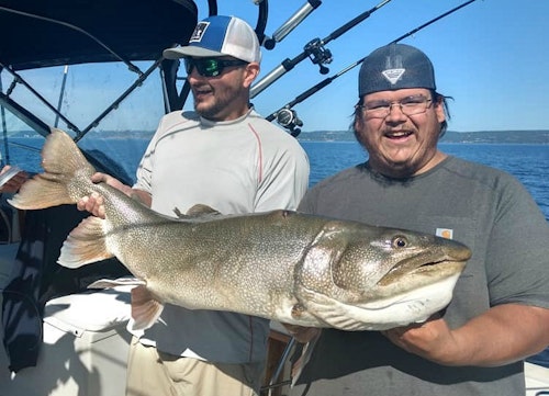 Instead of killing this trophy lake trout, angler Steven Gotchie (right) decided to let it go.