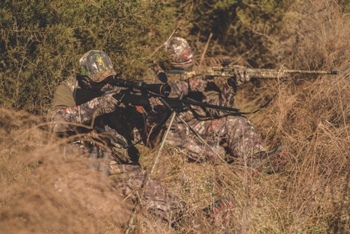 Buddy hunters often try to cover all the bases by mixing it up — one shooting a scattergun and the other a rifle. That way, they have options should a coyote hang up at 200 yards or charge the setup at 30 yards.  Photo: Howard Communications