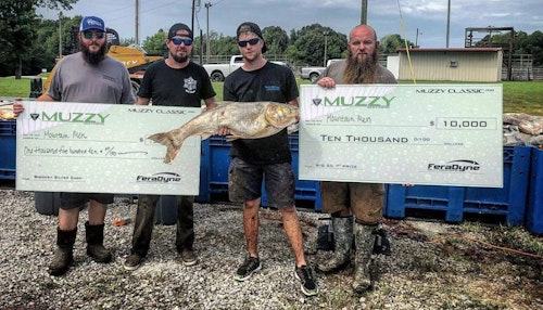 Team Mountain Men with their first-place checks for winning the Big 20 and Largest Silver Carp categories.