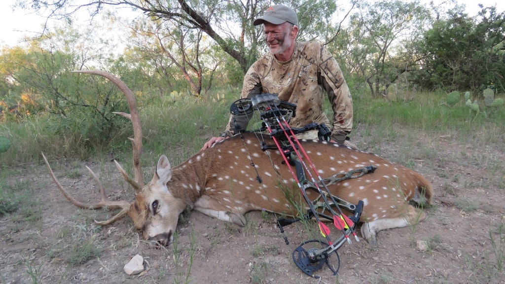 The author with a dandy Texas axis buck taken with SOE Hunts and a Bear compound bow, Caron Express shafts, and a 100-grain Rage Trypan broadhead.