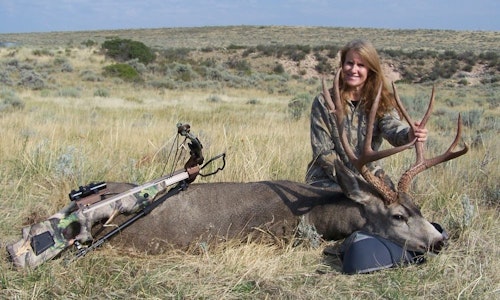 Debra Bradbury with a mature muley buck taken with a crossbow after waiting patiently in a ground blind.