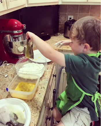 The author's son coats the bluegill in egg, then dredges each fish in cornmeal mix. Photo: Amy Hatfield 