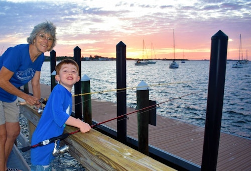 Grandma and grandson caught grouper and snapper during a sunrise fishing session on historic Bridge Street Pier at Bradenton Beach, Florida.